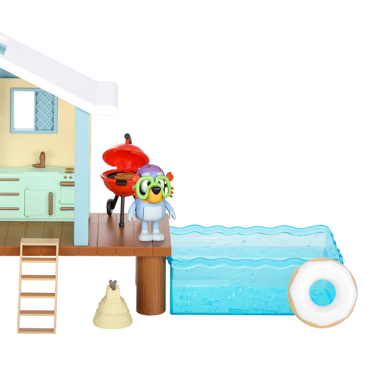 Beach cabin playset with side view: grill, steps, character figure, and blue pool