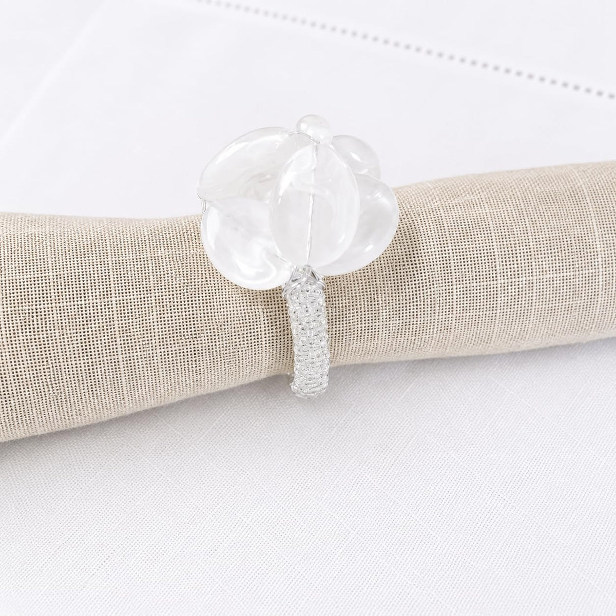 White oval gemstone beaded napkin ring with glittery textured band