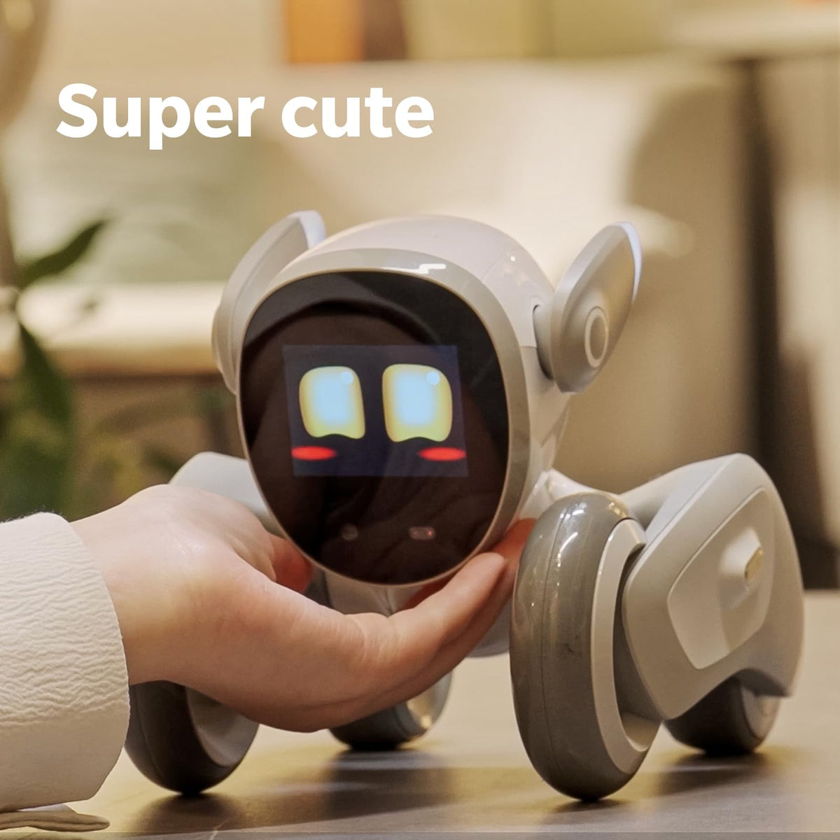 White robotic dog with glowing eyes, viewed front while held in a hand