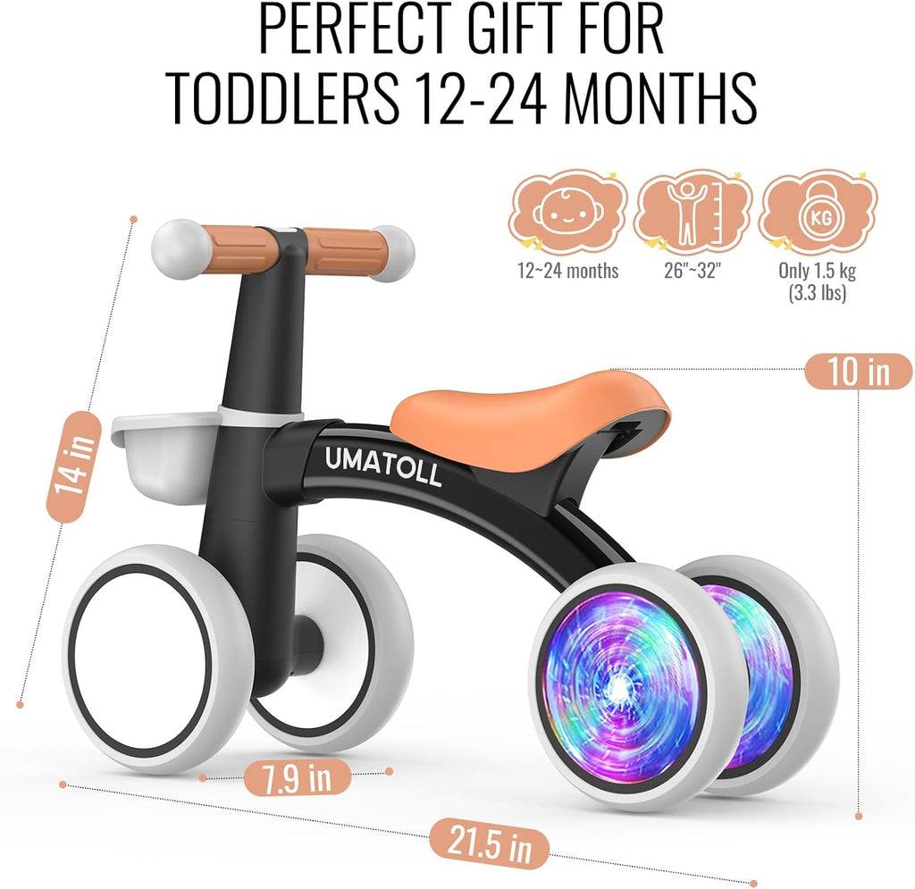 Black toddler balance bike with orange seat and handle, white wheels, glowing LED light effect