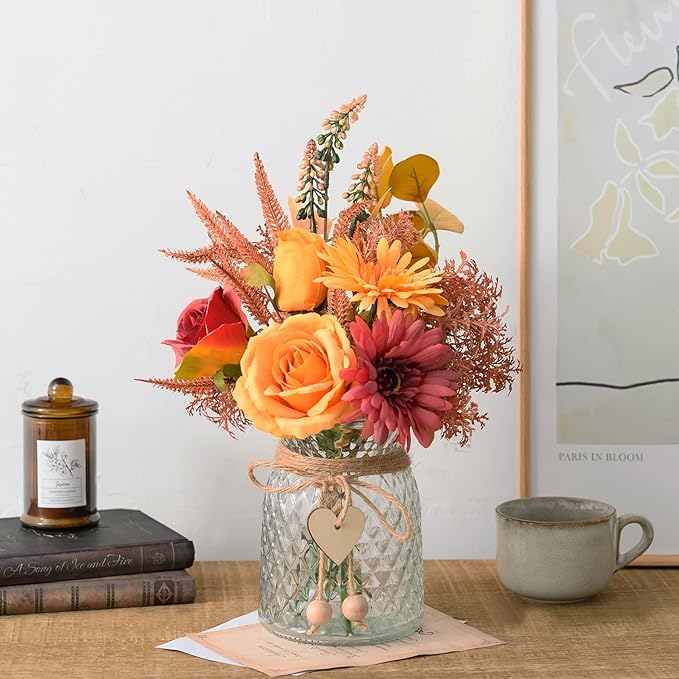 Colorful faux flower bouquet in textured glass vase with small heart tags and twine