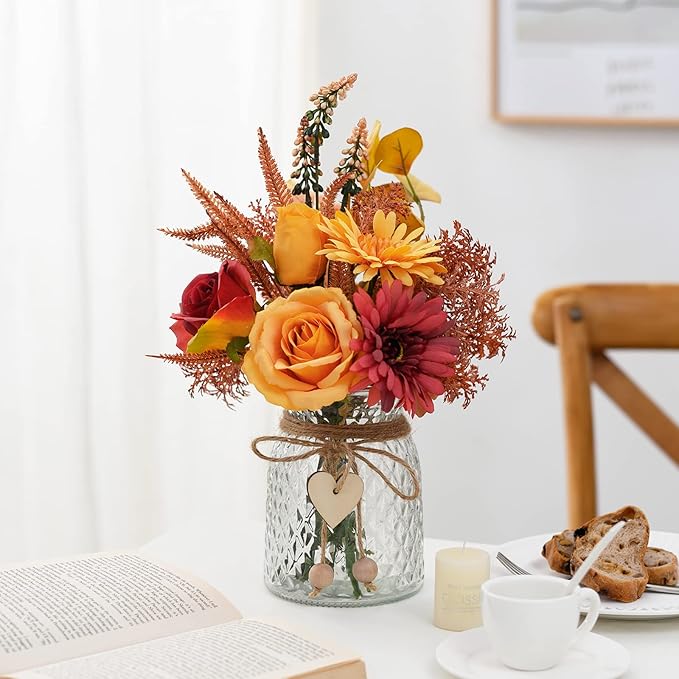Colorful faux flower arrangement in textured glass vase with heart charm and twine wrap