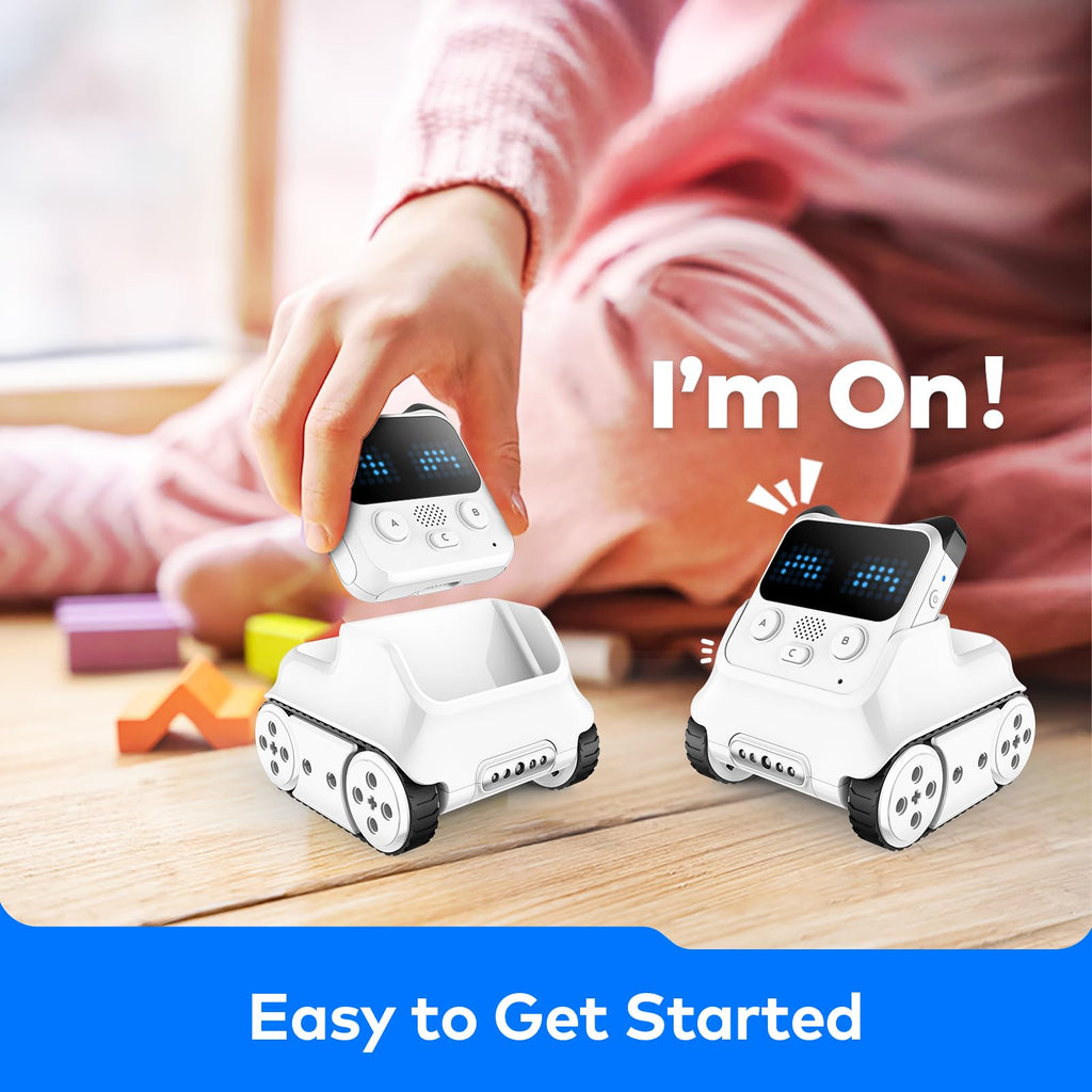 White coding robot toy with blue LED screen, being controlled on a tabletop.