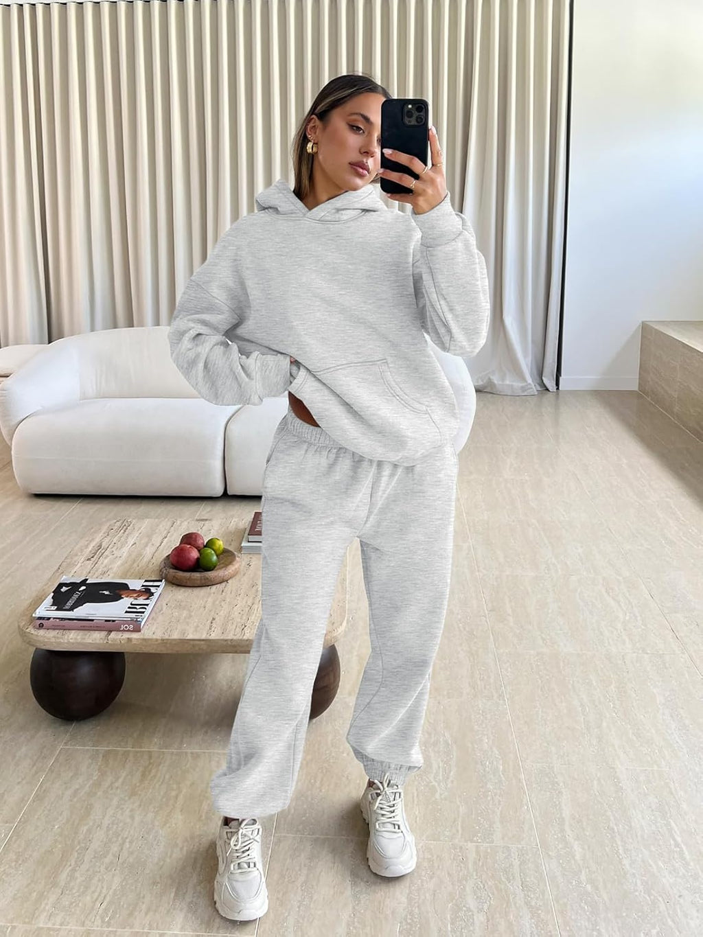 Light gray hoodie and jogger sweatpants lounge set with sneakers, model wearing set