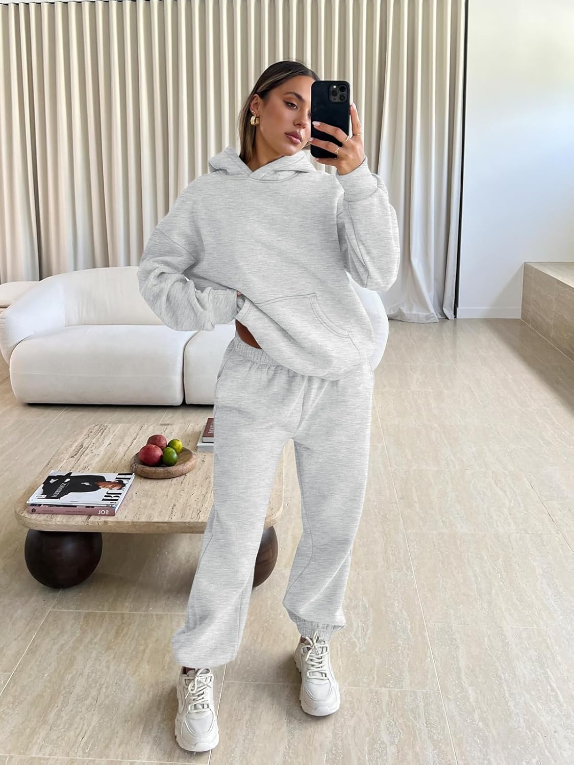 Light gray hoodie and jogger sweatpants lounge set with sneakers, model wearing set