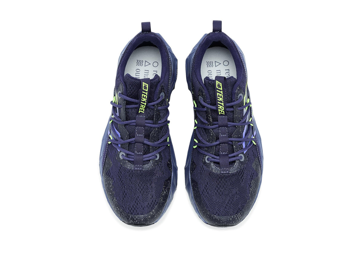 Pair of navy trail running shoes with neon green laces and logo on tongue
