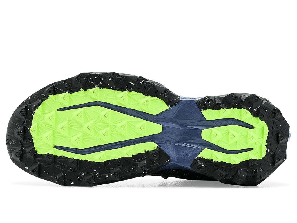 Outsole view of trail running shoe with black tread and bright neon green traction panels