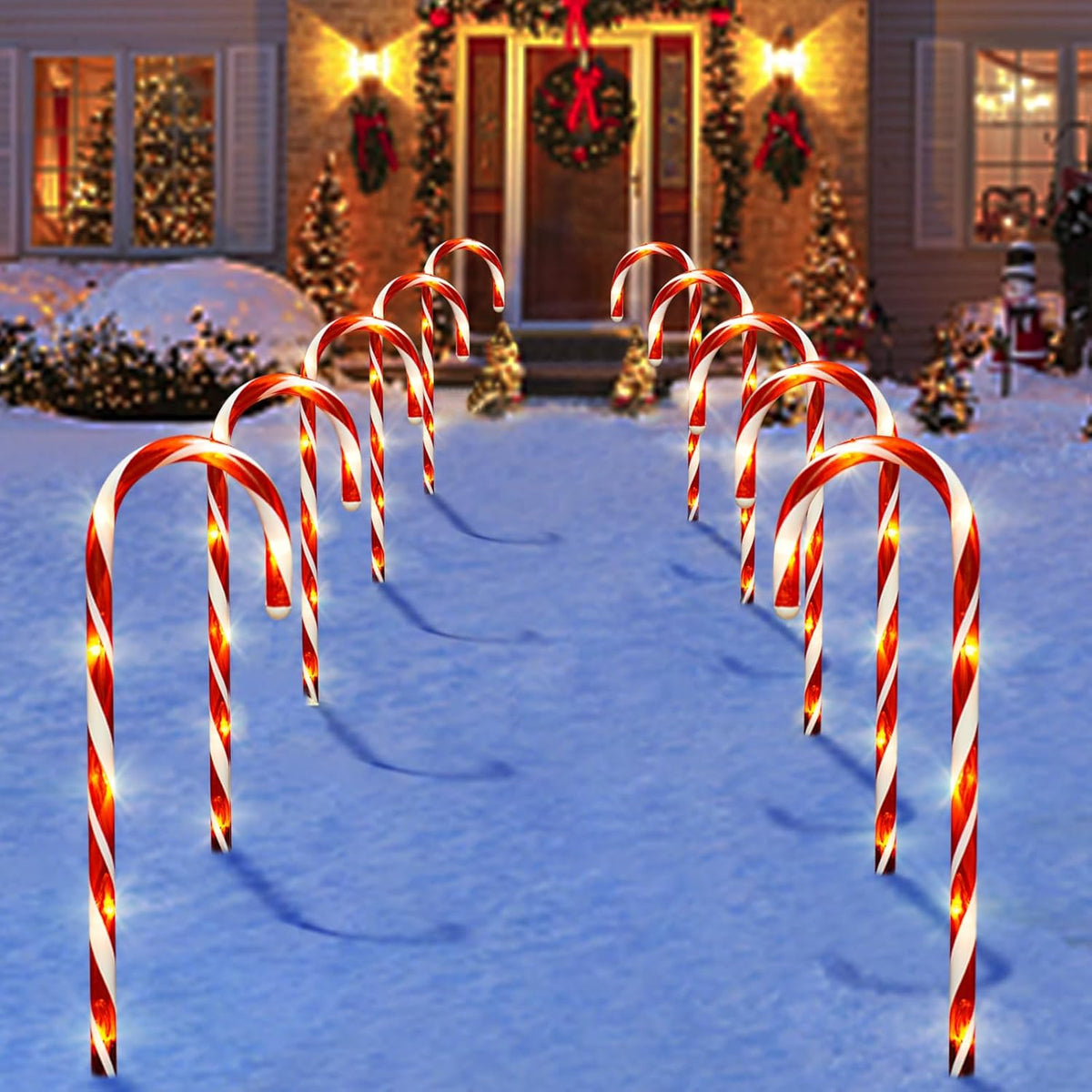 Candy cane solar pathway lights set, red and white striped bulbs forming glowing arches