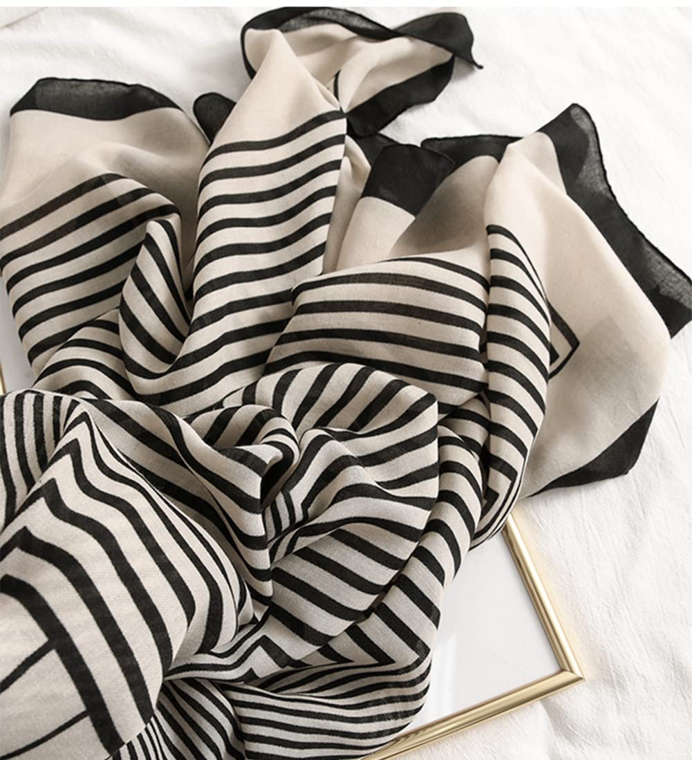 Black-and-off-white striped scarf with bold wavy stripes and draped layered folds