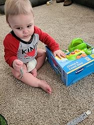 Green dinosaur counting toy with numbered panels and colorful details