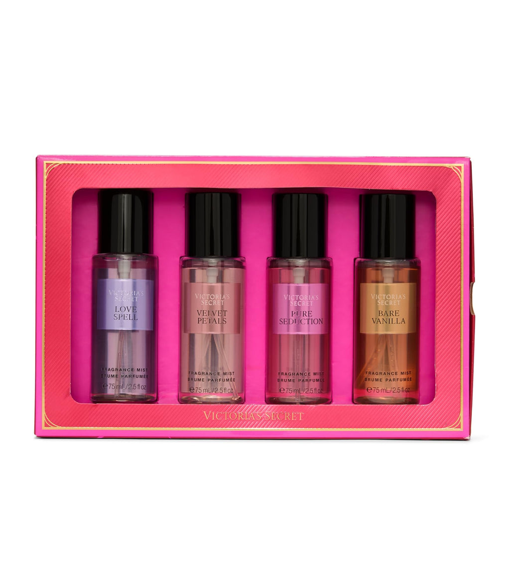 Four mini fragrance mist bottles in a pink gift box with black caps