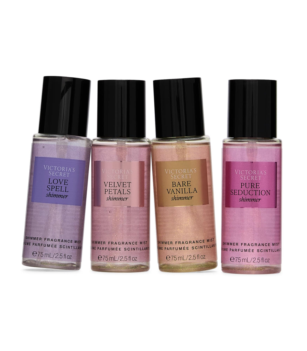 Close-up of four mini fragrance mist bottles with purple, pink, and brown tones.