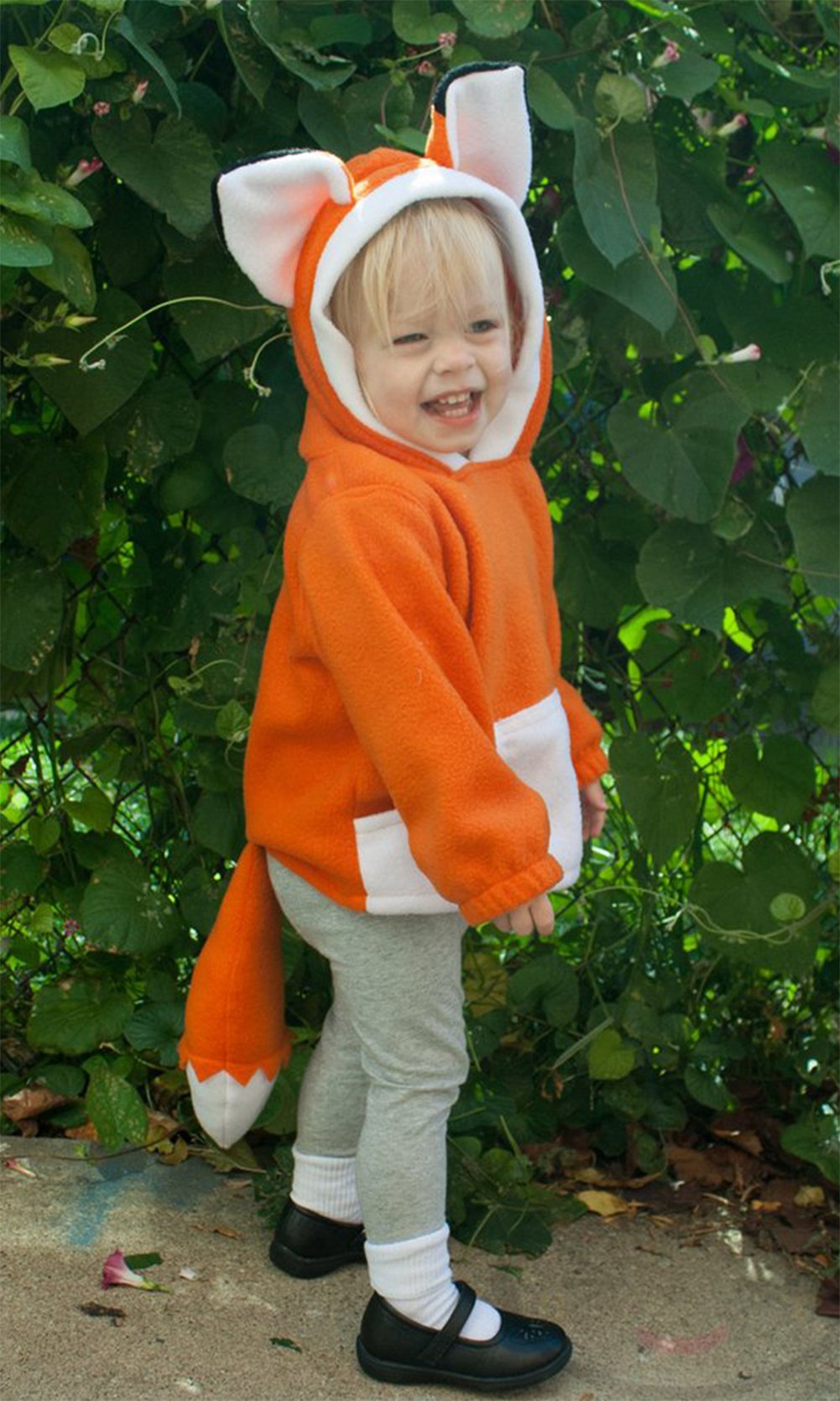 Orange animal-ear hoodie with white-trim hood and long sleeves worn by child outdoors.