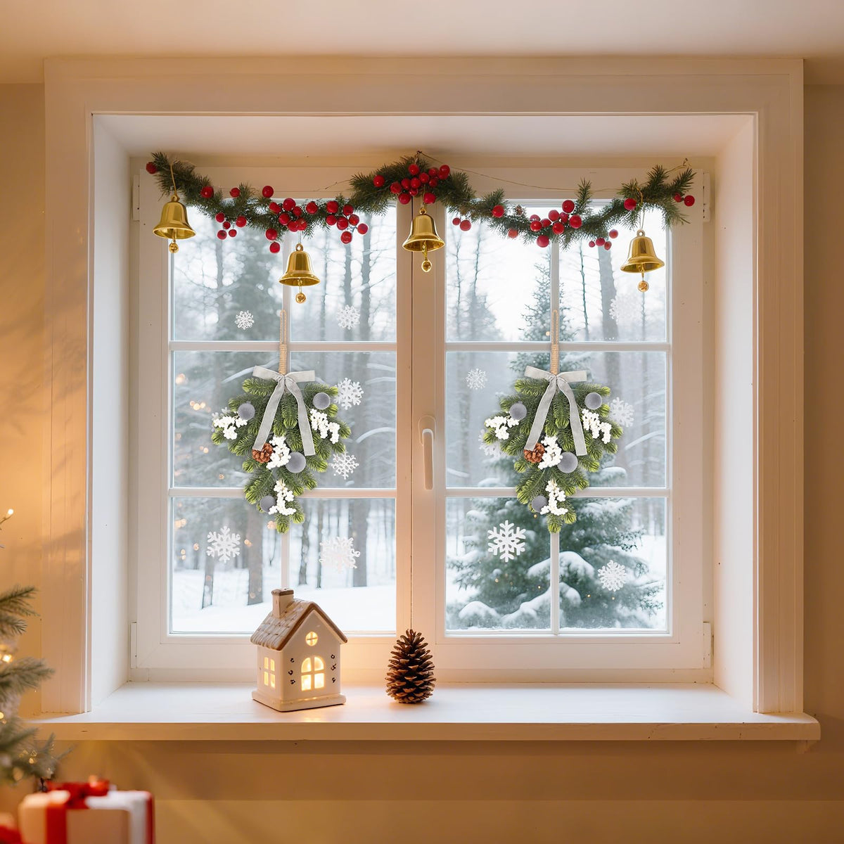 Window sill decorated with small hanging wreaths, bells, and festive ornaments