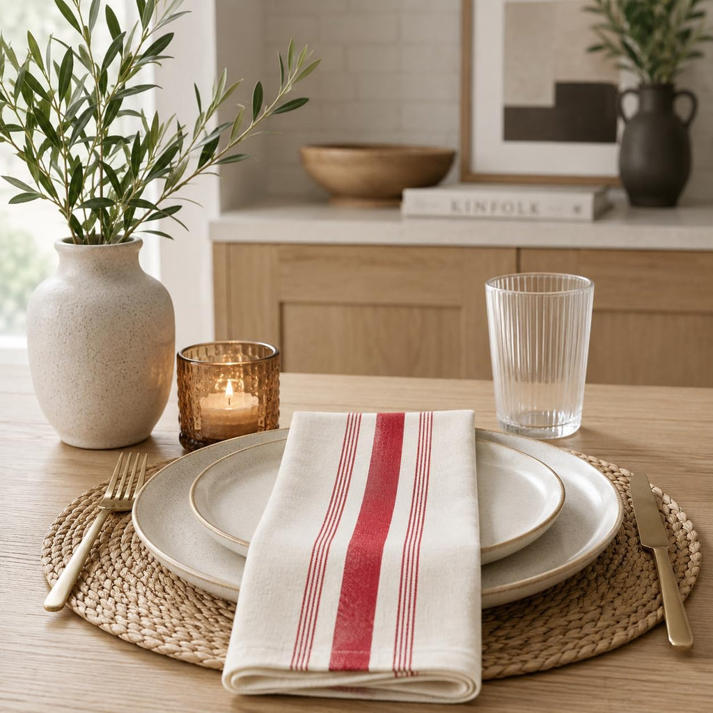 Folded beige dinner napkin with vertical red and white stripe bands