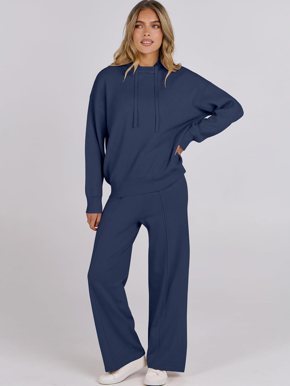 Navy two-piece lounge set on model: pullover hoodie with drawstring and wide-leg pants