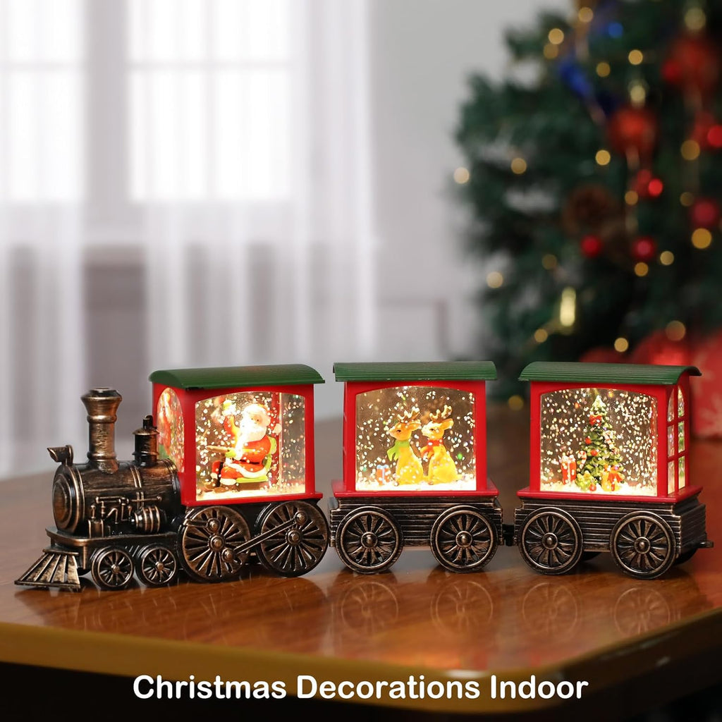 Christmas train snow globe lantern with glowing Santa scenes on a tabletop