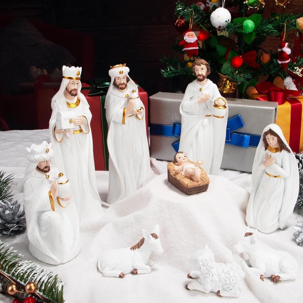 White resin nativity set with standing wise men, angel, shepherd, and lamb figures