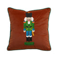 Brown velvet square pillow cover with full nutcracker embroidery and dark green edge piping.