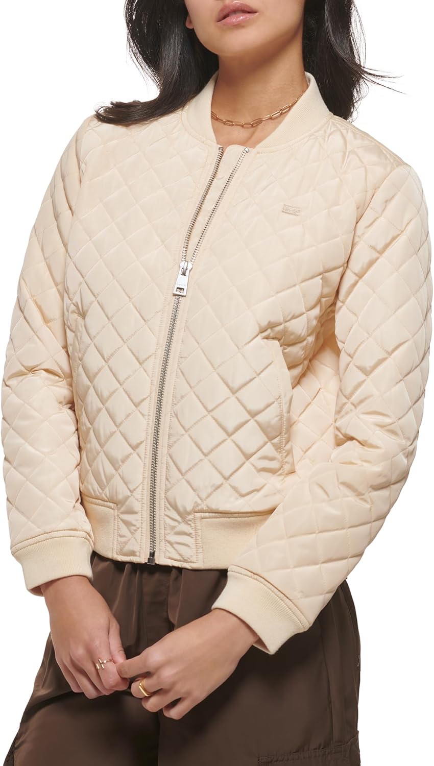 Quilted bomber jacket in cream with front zipper, mock-neck trim, and pockets