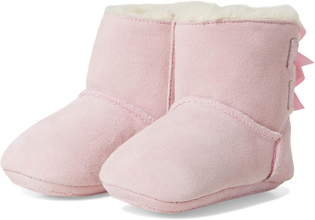 Pink baby suede booties with cushioned lining and bow detail on the side
