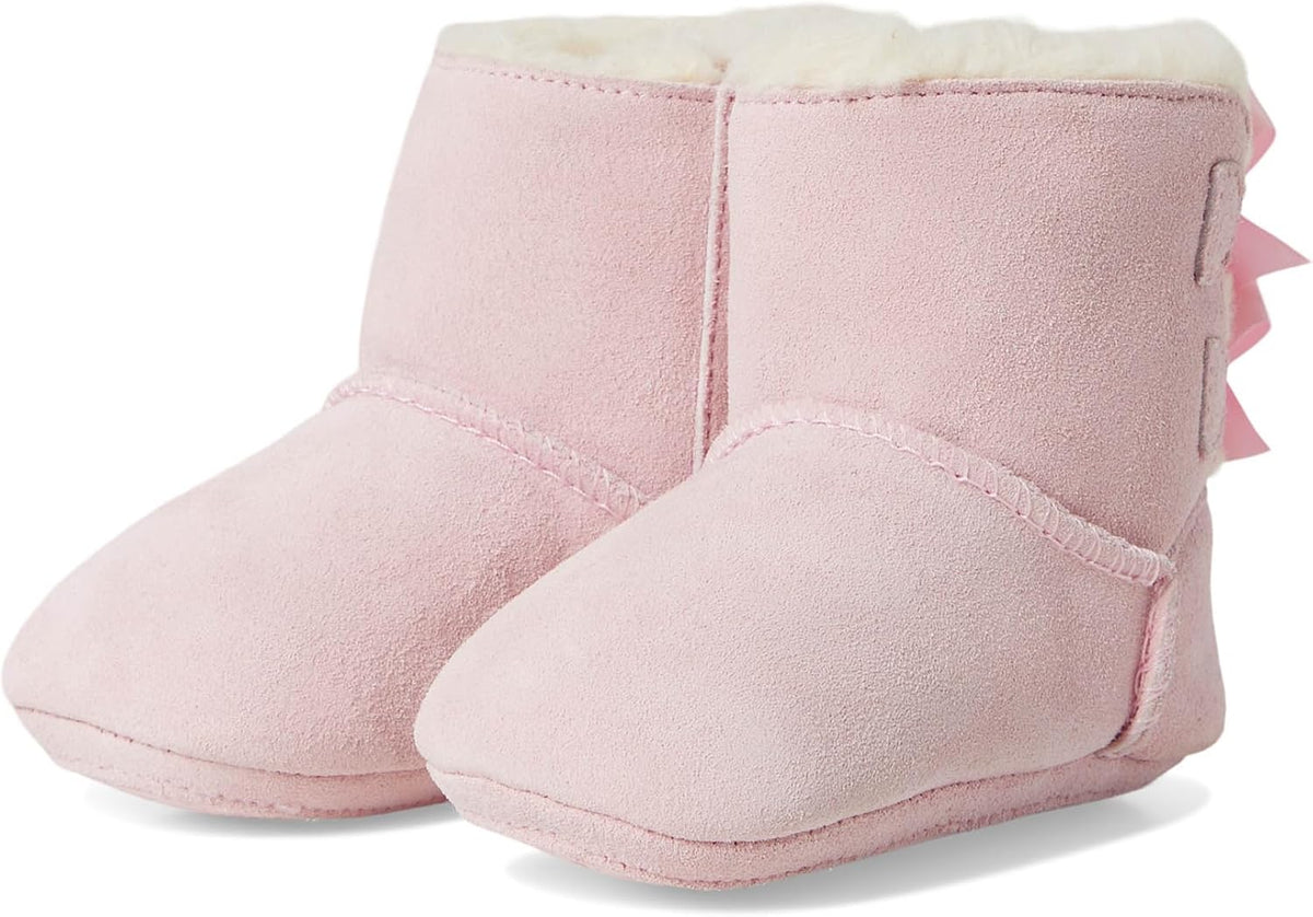 Pink baby suede booties with plush lining and bow accents on the side