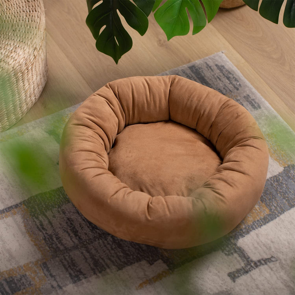 Brown round dog bed cushion with plush bolstered rim and inner bowl.