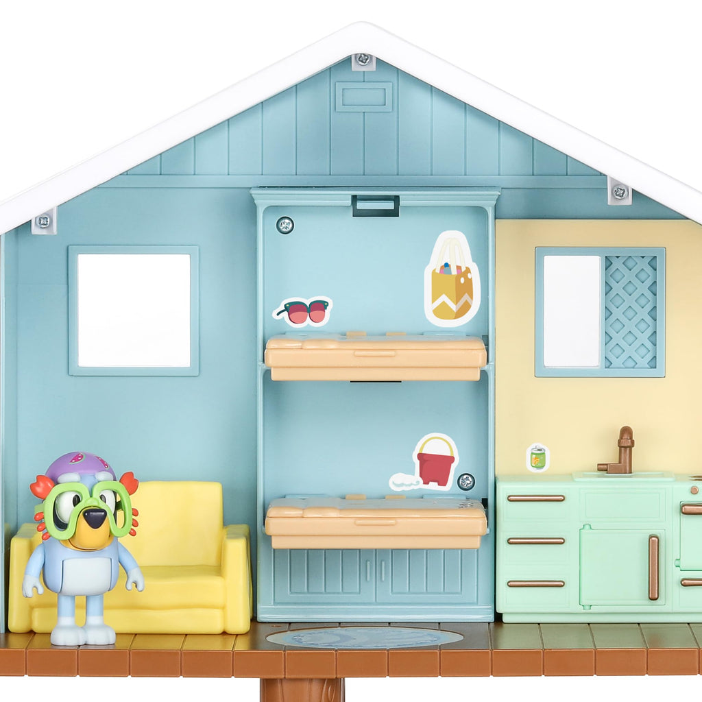 Beach cabin playset interior view with kitchen fixtures and character figure on platform