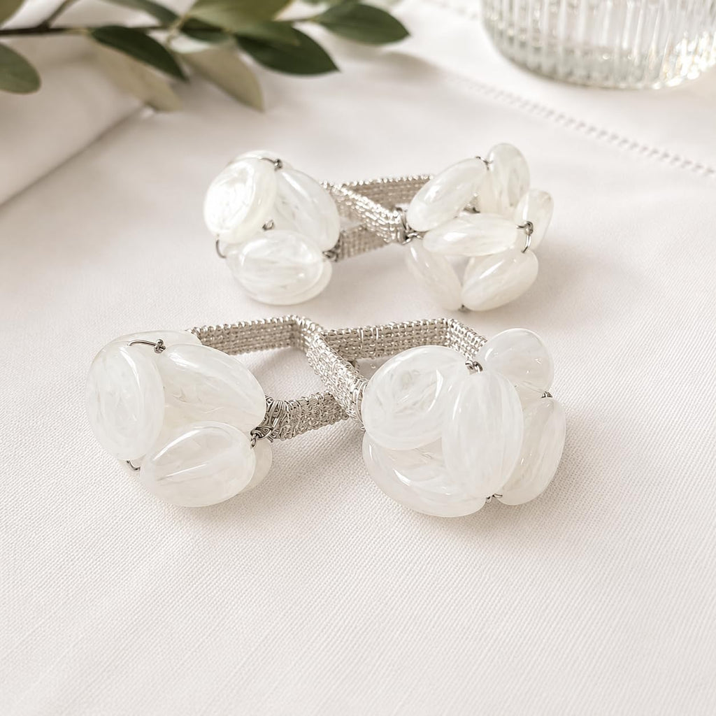 Set of white gemstone beaded napkin rings with clustered oval glass stones