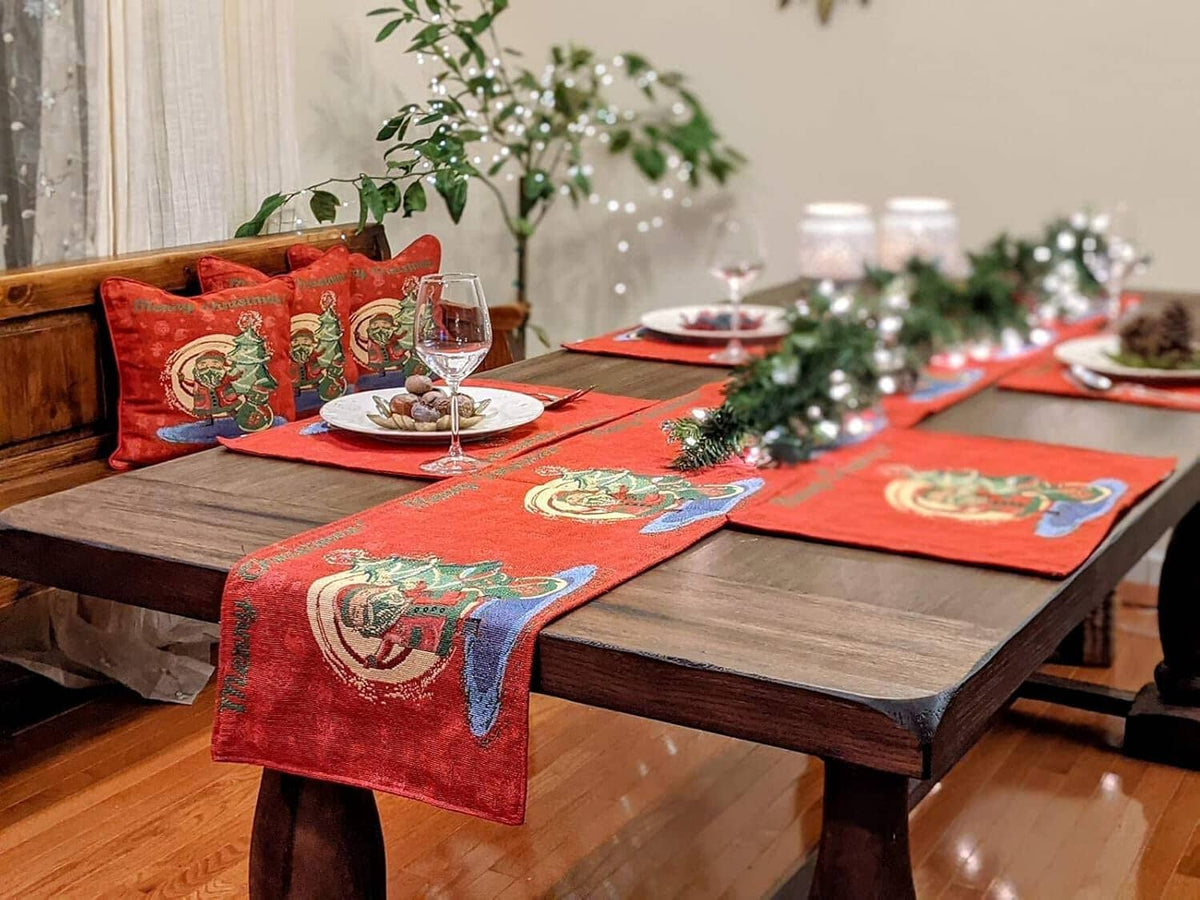 Red woven tapestry table runner with repeating Santa-and-tree design