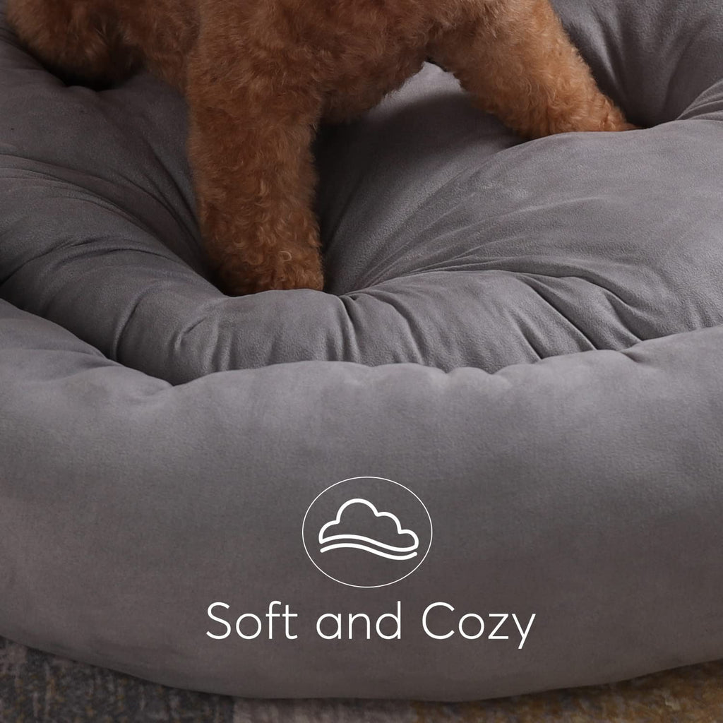 Gray round dog bed cushion with bolstered rim and “Soft and Cozy” label.