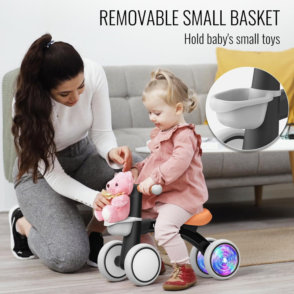 Toddler ride-on balance bike with white front basket, black frame, orange seat, glowing wheel