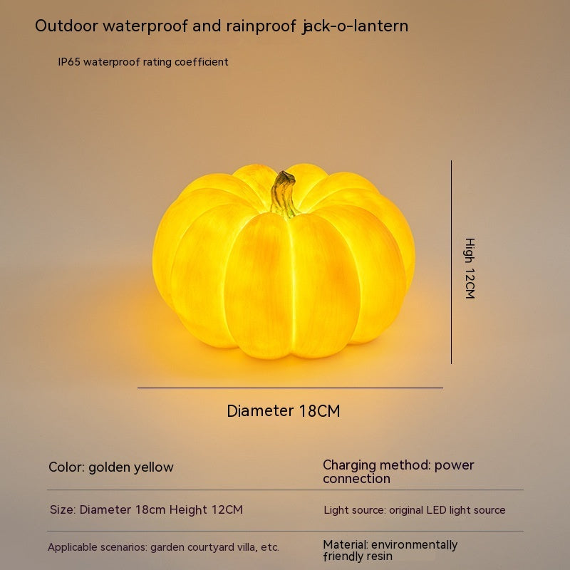 Golden yellow pumpkin-shaped outdoor LED light with hanging loop, size shown
