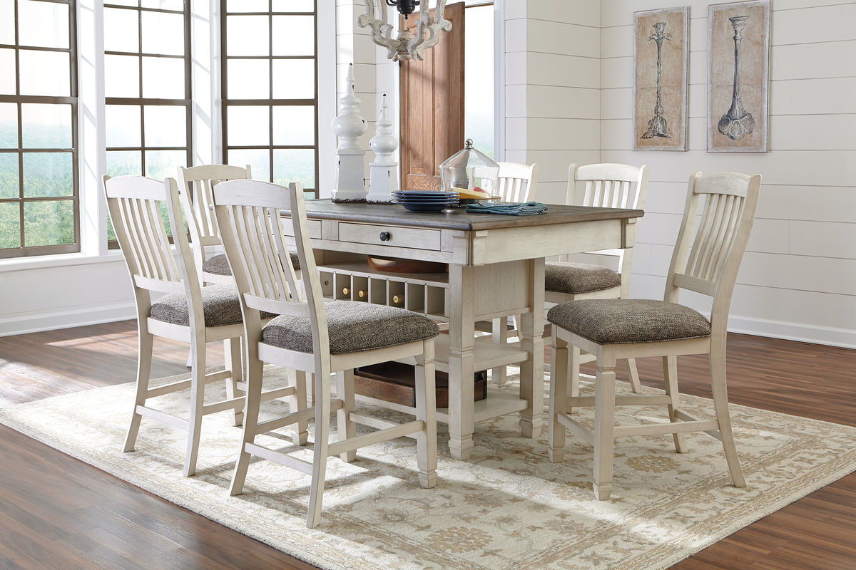Rectangular dining table with beige finish and gray-cushioned chairs, plus open storage server.