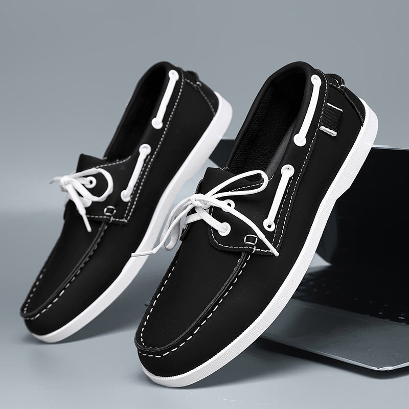 Men's black loafers with white laces, white side stripes, and white sole