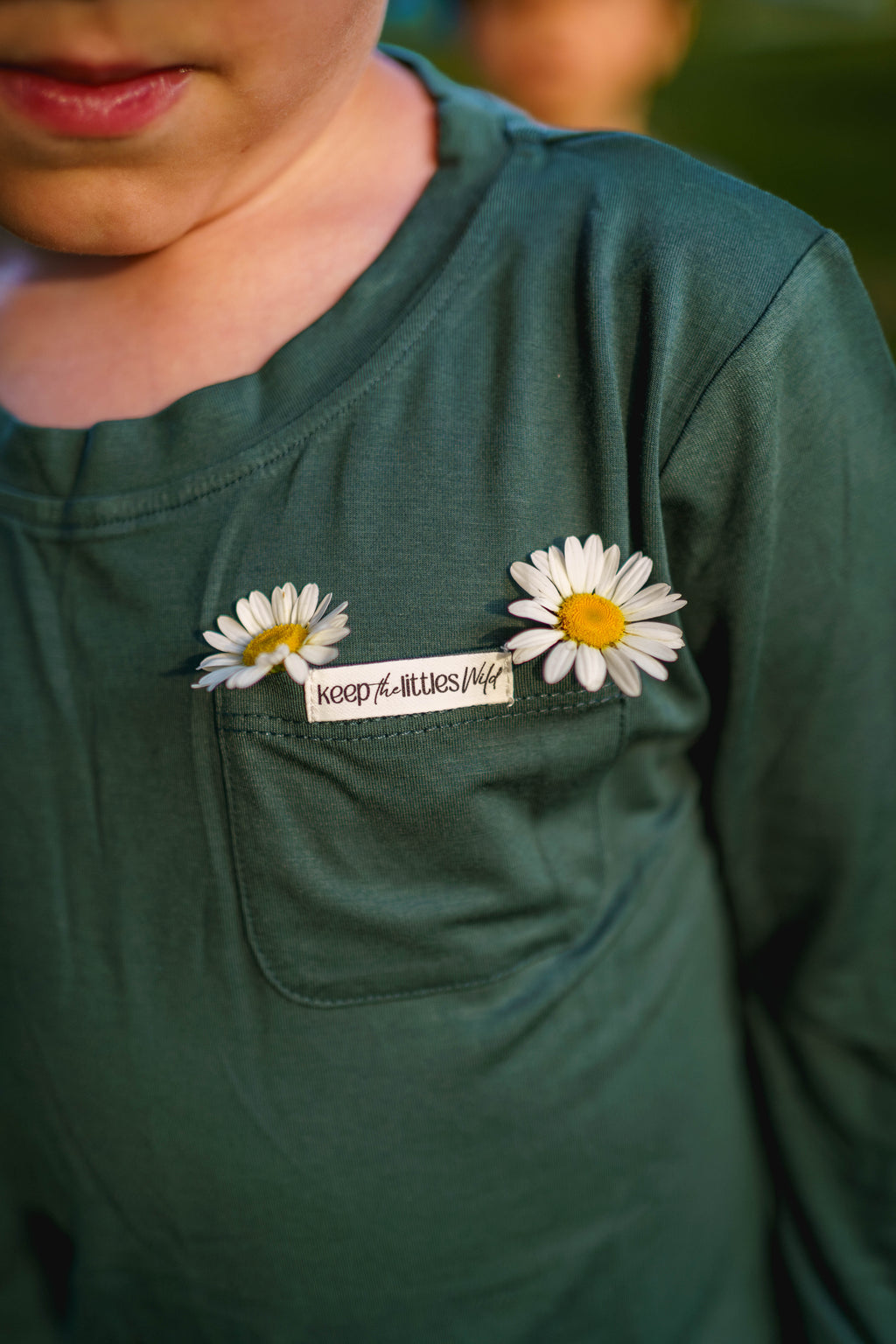 Hunter green bamboo long-sleeve shirt with chest pocket and daisy embellishment