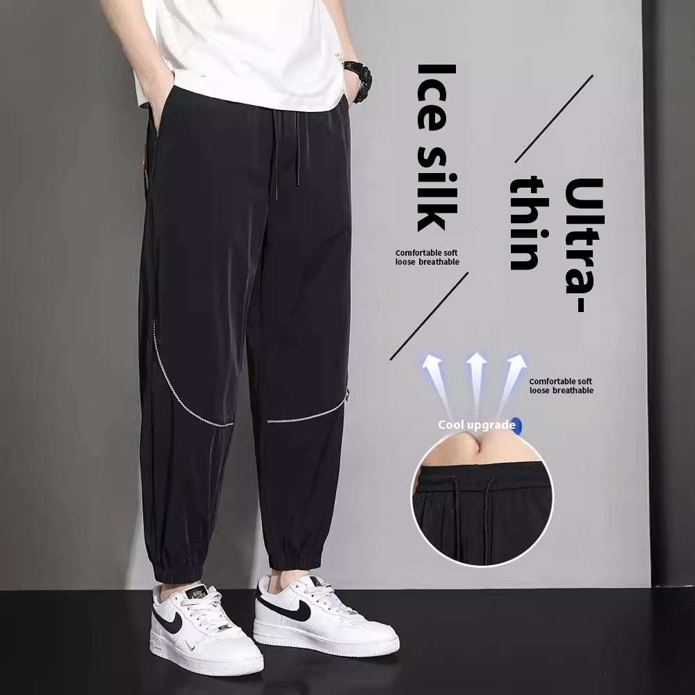 Men's tapered casual pants in black with drawstring waist and cuffed ankle hems