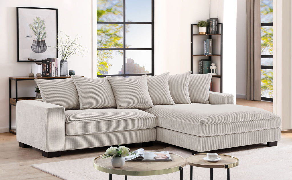Oversized sectional sofa with chaise, light beige upholstery with multiple throw pillows