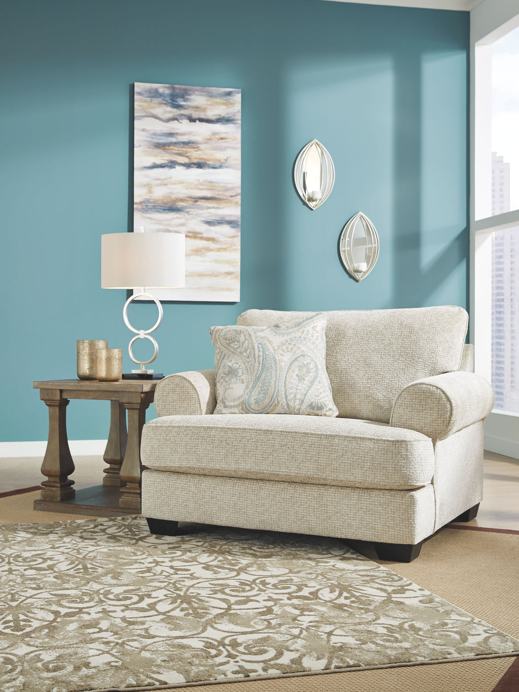 Sandstone upholstered chair with patterned pillow and rounded armrests
