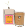 Aromatic candle in amber glass jar with metal charm; pink mimosa box