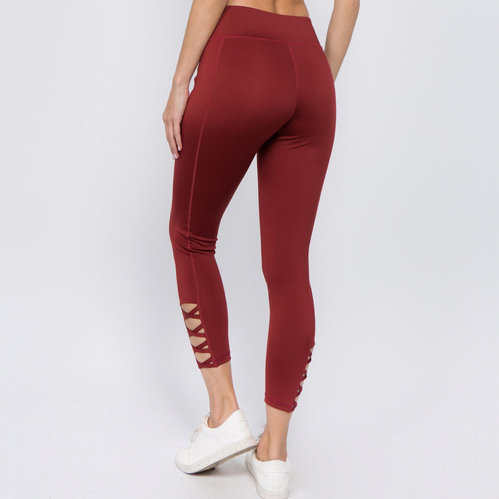 Wine active leggings with criss-cross ankle cutouts, cropped length