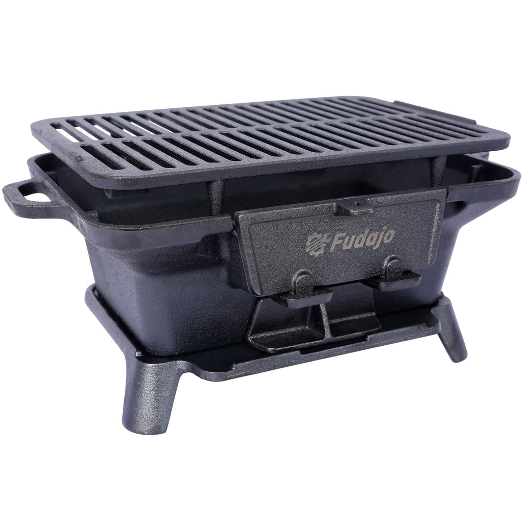 Oval cast iron tabletop grill with slotted grate and front control latch, dark charcoal