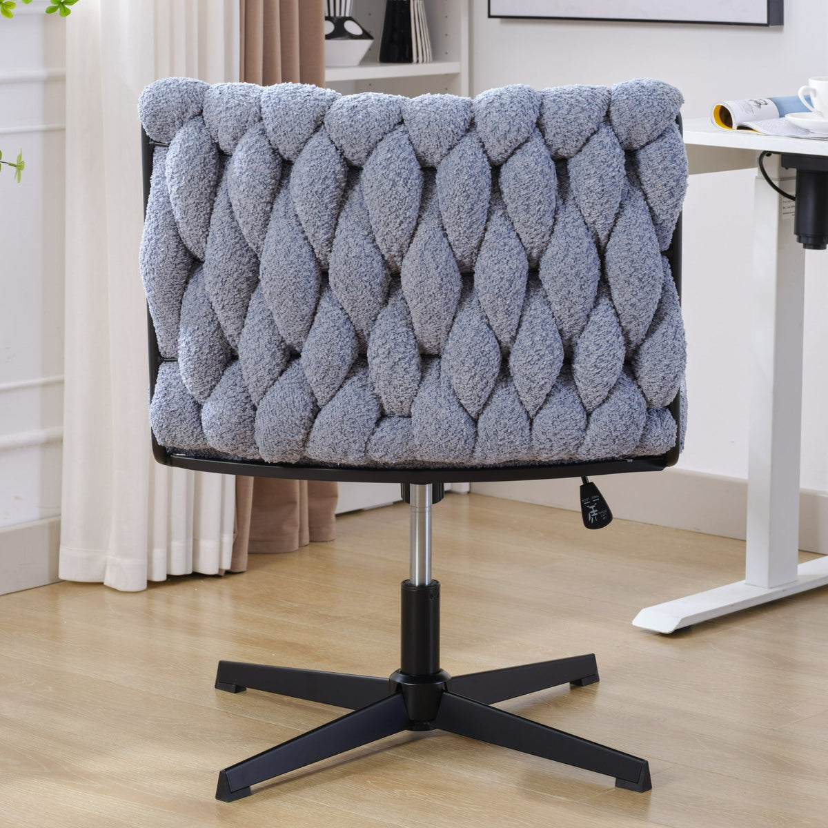Blue armless office desk chair with tufted backrest, padded seat, five-star base