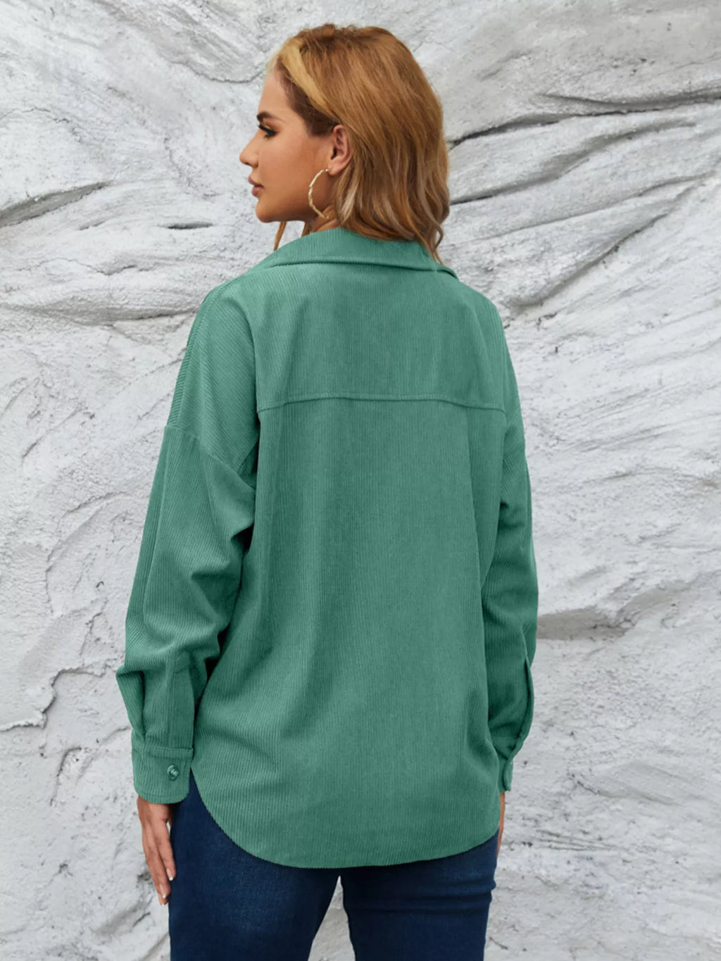 Teal-green corduroy button-up shirt from back with collar and yoke seam