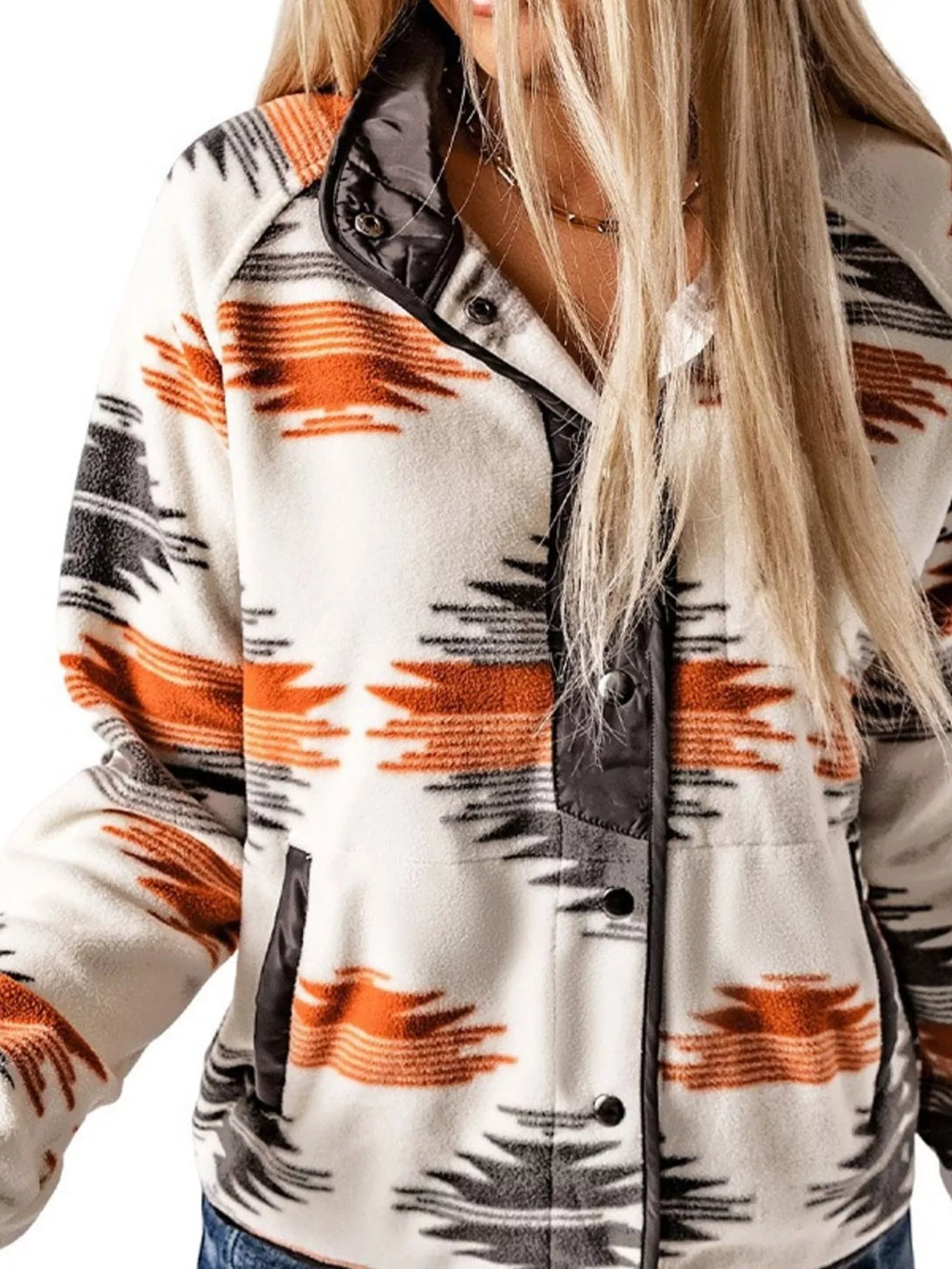 Geometric snap-down jacket close-up with black snap placket and orange, navy print
