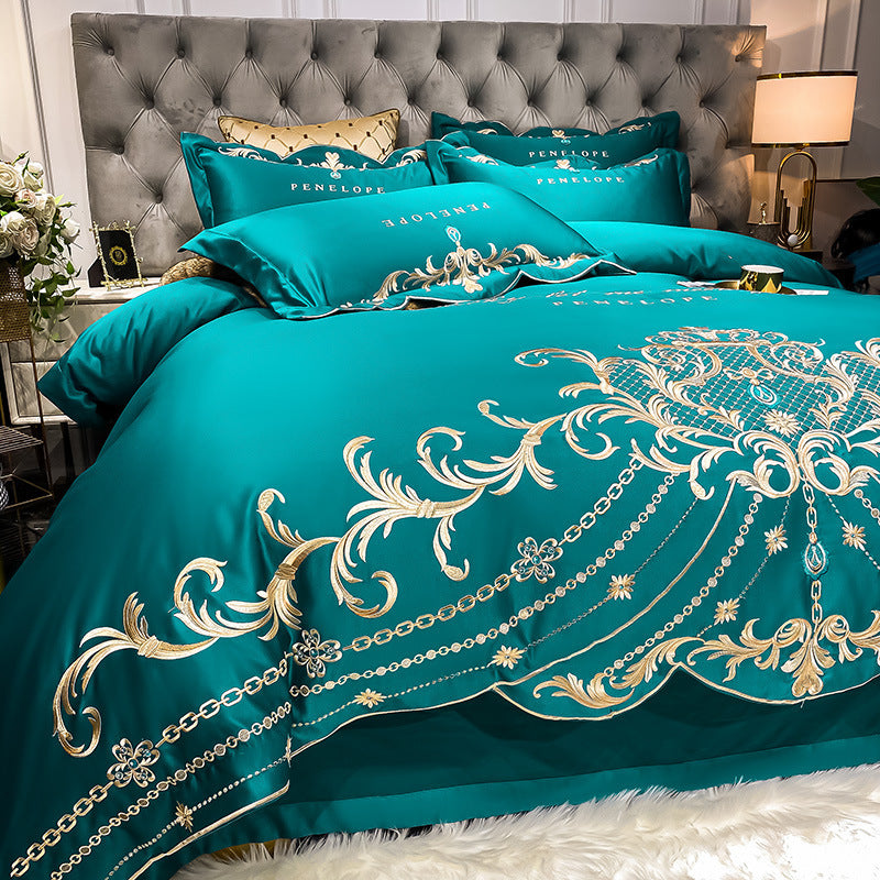 Teal quilted bed sheet set with gold ornate embroidery and matching pillowcases
