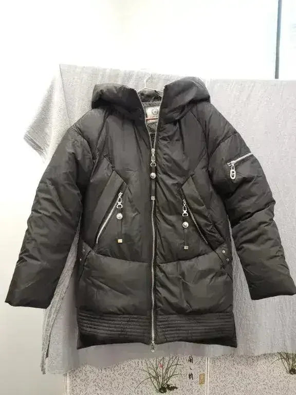 Black hooded padded parka jacket with front zipper and zip pockets, laid flat