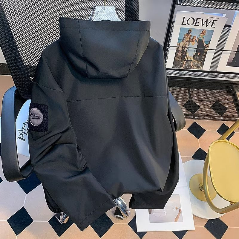 Black men's hooded soft shell jacket, back view with sleeve patch detail