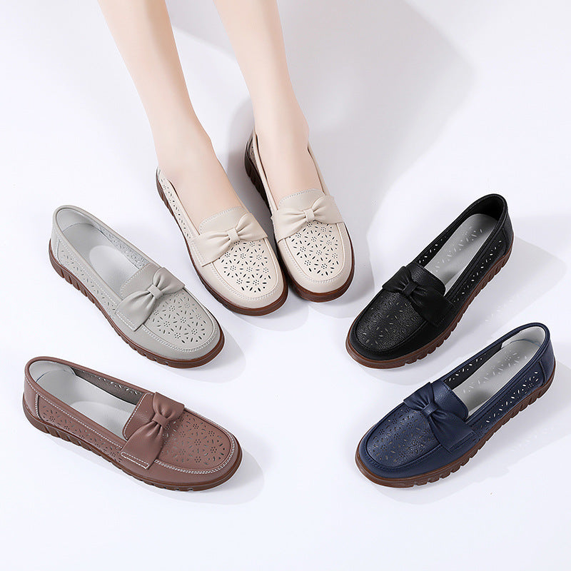 Women’s flat loafers in cream, black, brown, and navy with bow accents and rubber soles