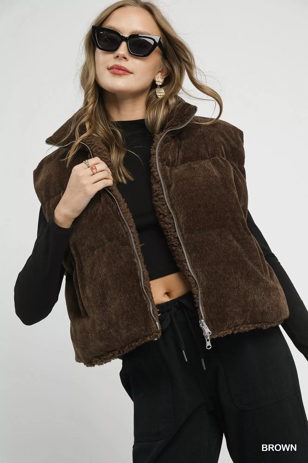 Brown sherpa-lined zip vest, front view with high collar and drawstring hem
